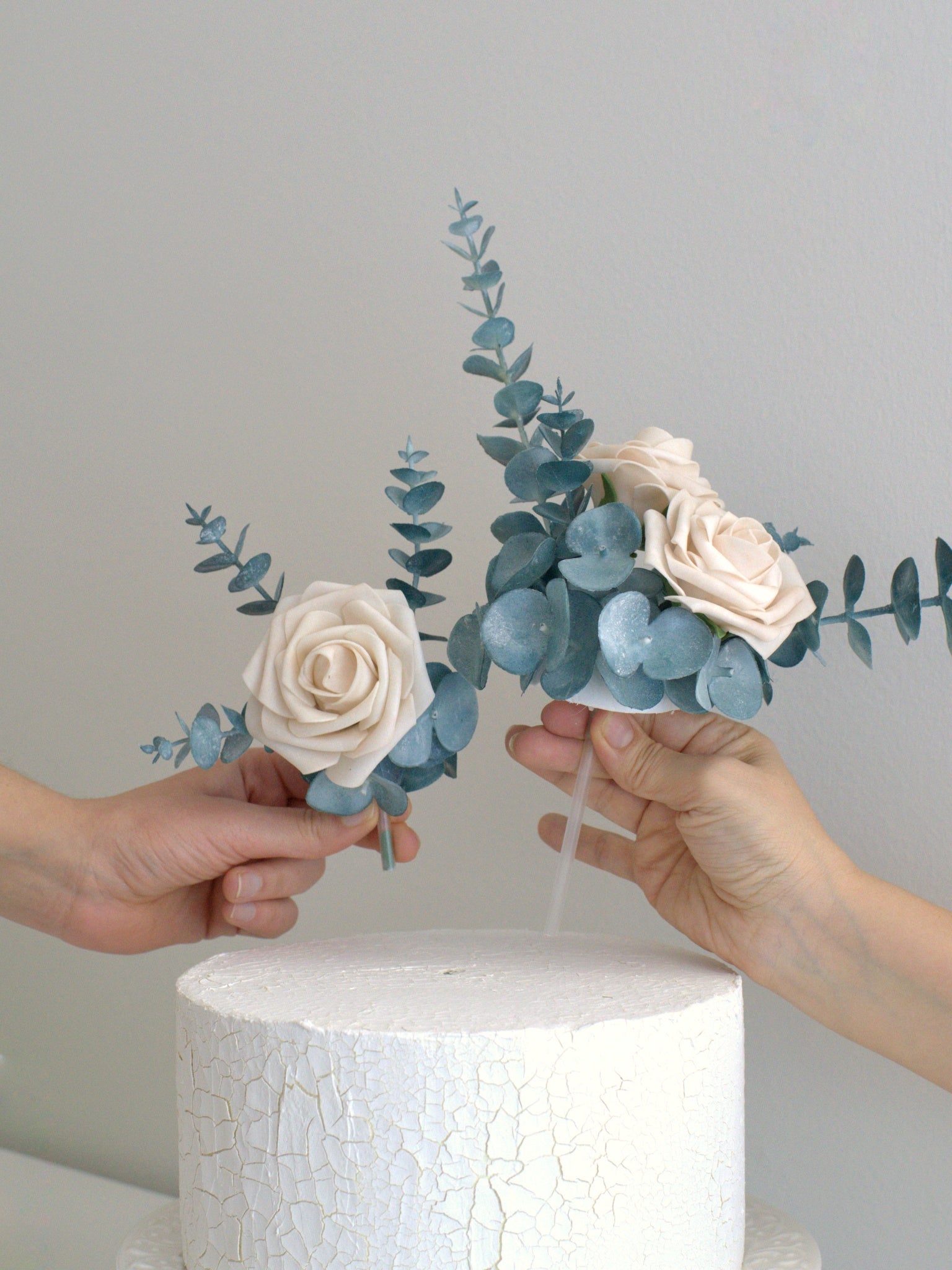 Simple to apply Rose and Eucalyptus Floral Cake Topper, effortlessly adding elegance to cakes with high-quality artificial flowers