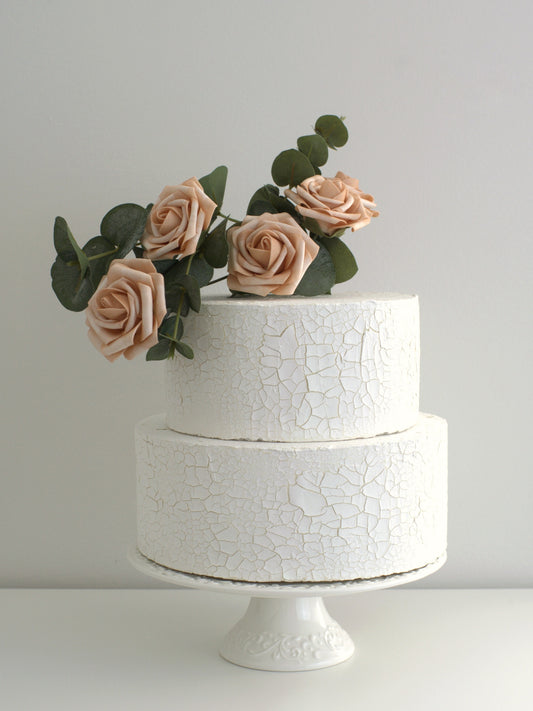 Four Beige Rose Cake Topper elegantly placed on a cake, featuring high-quality artificial flowers for weddings and special occasions.