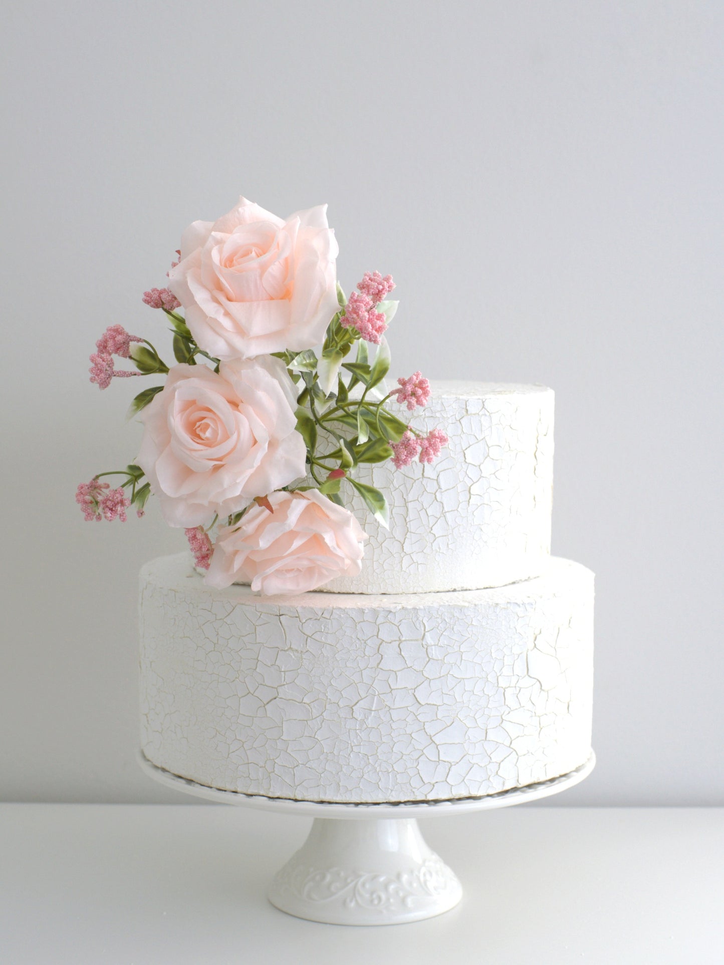 Tree Blush Rose Cake Side Accent elegantly placed on a cake, featuring high-quality artificial flowers for a sophisticated touch at weddings, birthdays, and special occasions.