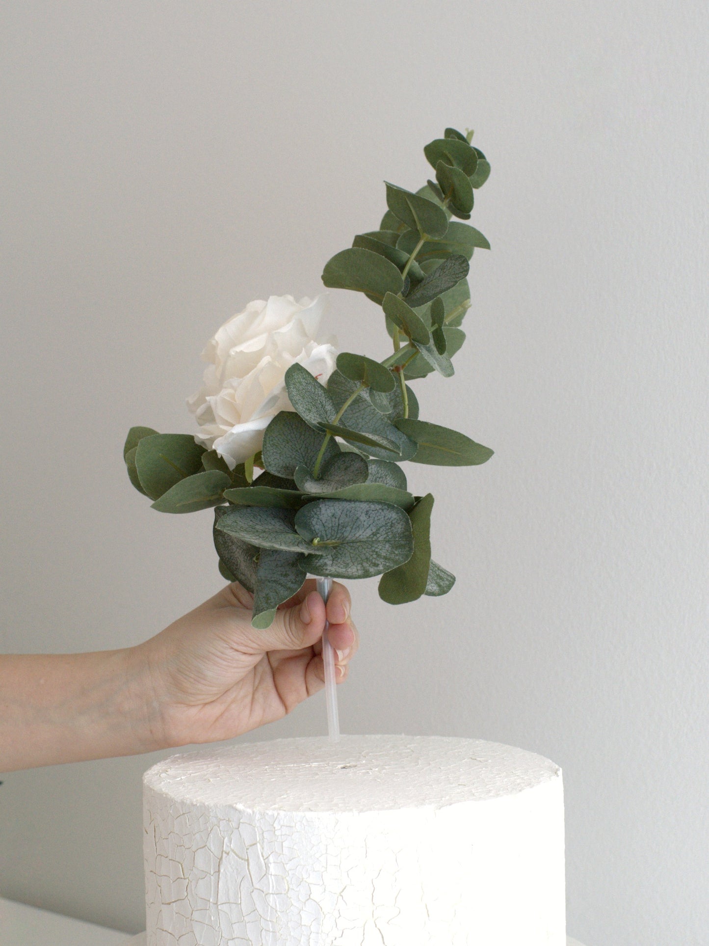 Close-up of Rose & Eucalyptus Cake Topper, showcasing intricate details and high-quality artificial petals for a realistic, luxurious finish.